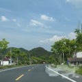 Long mountain road, blue sky and white clouds Royalty Free Stock Photo