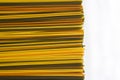 Long multicolored pasta in horizontal lines on white background