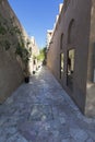 Long and narrow ally way in Dubai with brown buildings