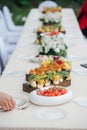 Long and narrow dining table outdoors, abundant in the food Royalty Free Stock Photo