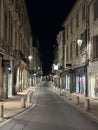 A long narrow street during the night in the old town Avignon, Provence-Alpes-CÃ´te d\'Azur, France, January 2023 Royalty Free Stock Photo