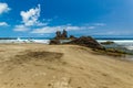 Long natural beach Benijo with footprints in the sand. Lava rock in the water. Blue sea horizon, natural sky background Royalty Free Stock Photo