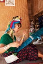 Long neck woman weaving