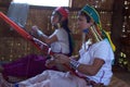 Long-necked women handweaving in small fabric on Inle lake in Burma, Asia Royalty Free Stock Photo