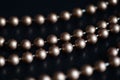 Long necklace of brown beads on a dark background Royalty Free Stock Photo