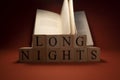 Long night writing and book concept made of wooden cubes. The background is red. Close up Royalty Free Stock Photo