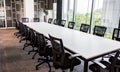 Long office table with a lot of chairs