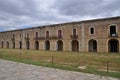 Long, old building with arched windows.