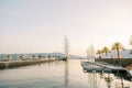 Long parallel piers with moored rows of yachts against the backdrop of mountains at sunset