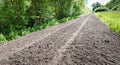 Long path of loose earth with a tire track