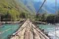 Long pedestrian suspension bridge over the mountain river Bzyb on a sunny autumn day in Abkhazia Royalty Free Stock Photo