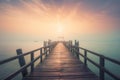 a long pier extending into the ocean with a sunset in the background