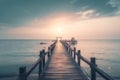 a long pier extending into the ocean at sunset with a boat in the distance