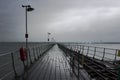 The long pier at Hythe in the south of England with its wooden walkway and railway line to the Southampton Ferry that leaves from