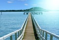 Long pier over blue sea water on a sunny day