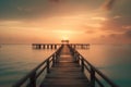 a long pier stretches out into the ocean at sunset with a pier in the foreground