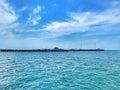 A Long Pier to the Ocean Between the Blue Sea and Blue Sky.