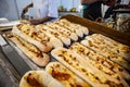 Long pizza bread with cheese and chourico sausage sold at Santa Iria Fair in Faro, Portugal Royalty Free Stock Photo