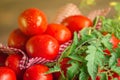 Long plum tomatoes with checkered red napkin on wooden table. Heap of fresh tomatoes Royalty Free Stock Photo