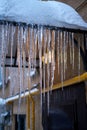 Long pointed backlit icicles on a roof