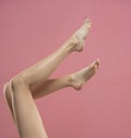 Long pretty smooth woman legs isolated on pink background Royalty Free Stock Photo