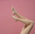 Long pretty smooth woman legs isolated on pink background Royalty Free Stock Photo