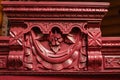 Long process of furniture patination. Red colored wooden cupboard with brilliant carved ornaments. Eco-friendly re-usage Royalty Free Stock Photo