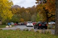 Long queue of cars trying to get a spot at the popular parking lot in the forest area of Torup, southern Sweden, on a warm autumn