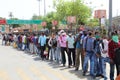 Long queue of Indian migrant laborers outside the railway station waiting to leave the city due to covid-19 pandemic.