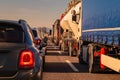 Long queue of trucks and cars as part of a traffic jam on a motorway in italy, europe on a sunny day Royalty Free Stock Photo