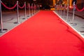 Long red carpet between rope barriers on entrance.