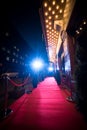 Long red carpet between rope barriers on entrance.