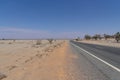 A long road alongside red dirt desert at outback rural of New South Wales, Australia. Royalty Free Stock Photo