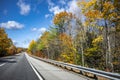 Long road calling the traveler on a journey with picturesque autumn maple trees along the road in Vermont Royalty Free Stock Photo