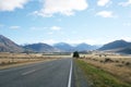 A long road leading to the snow-capped mountains in New Zealand. Royalty Free Stock Photo