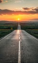 Long road stretches into the distance under dramatic sunset. Royalty Free Stock Photo