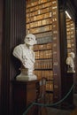 The Long Room interior Of The Old Library At Trinity College. Marble busts of great people and shelves with antique tomes Royalty Free Stock Photo