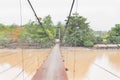 long rope bridge across the river in village at Thailand country