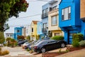 Long row of California houses with variety of colors and vehicles parked in driveways