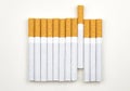 Long row of cigarettes with orange filter tips Royalty Free Stock Photo