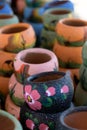 Long row of colorful ceramic pots in pottery workshop Royalty Free Stock Photo