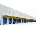 Long Row of Loading Docks with Blue Doors on a Modern Warehouse Exterior industrial logistics Royalty Free Stock Photo