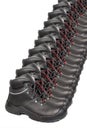 Long row of many pair of new black work boots made of genuine leather with a reinforced cape, the concept of special shoes for Royalty Free Stock Photo