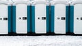 Long row of mobile toilets outside on the snowy ground. Bio toilets outdoors Royalty Free Stock Photo