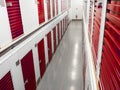 Long row of red color doors of self storage facility. Service to keep safe extra belongings. Nobody. Selective focus. Clean and Royalty Free Stock Photo