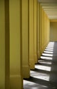 Long row of yellow columns Royalty Free Stock Photo