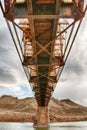 Long rusted bridge looking up to the underbelly