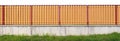 Long rustic wooden fence made of orange color certical l boards isolated Royalty Free Stock Photo