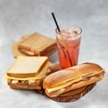 Long sandwich with ham, cheese, tomatoes, red onion and lettuce with red cocktail Royalty Free Stock Photo