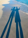 long shadow from a couple of a guy and a girl, on the sand of Varadero beach in Cuba. Evening, sunset. Royalty Free Stock Photo